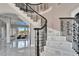 Elegant staircase with wrought iron railing and marble steps, leading to the upper level of the home at 9401 93Rd St, Seminole, FL 33777