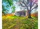 Large backyard with a screened-in lanai and privacy fence, surrounded by mature trees and lush greenery at 10232 Grant Creek Dr, Tampa, FL 33647