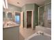 Bright bathroom featuring double sinks, large mirror, walk-in shower and a bathtub at 10232 Grant Creek Dr, Tampa, FL 33647