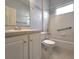 Cozy bathroom featuring a tub with tiled walls and a single sink vanity with white cabinets at 10232 Grant Creek Dr, Tampa, FL 33647