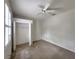Clean, carpeted bedroom with large closet and a ceiling fan at 10232 Grant Creek Dr, Tampa, FL 33647