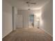 Bright bedroom showcasing a neutral color scheme, ceiling fan, and doorways to an en-suite bathroom and closet at 10232 Grant Creek Dr, Tampa, FL 33647