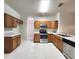 Well-lit kitchen with stainless steel appliances, wood cabinets, and countertops at 10232 Grant Creek Dr, Tampa, FL 33647