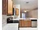 Kitchen features stainless steel appliances and oak cabinets, adjacent to the living room at 10232 Grant Creek Dr, Tampa, FL 33647