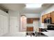 Efficient kitchen with wood cabinets, stainless steel appliances, and a double basin sink at 10232 Grant Creek Dr, Tampa, FL 33647
