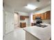 Functional kitchen with wood cabinetry and stainless steel appliances adjacent to a doorway at 10232 Grant Creek Dr, Tampa, FL 33647