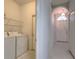 Laundry room leads to the hallway with an arched doorway with a window above the main entrance at 10232 Grant Creek Dr, Tampa, FL 33647