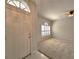 Bright living room with carpet flooring, neutral walls, and a white front door at 10232 Grant Creek Dr, Tampa, FL 33647
