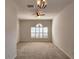 Bright, carpeted living room with a ceiling fan and large window featuring white shutters at 10232 Grant Creek Dr, Tampa, FL 33647