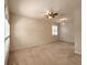 Spacious living room featuring carpet flooring, neutral walls, and a ceiling fan at 10232 Grant Creek Dr, Tampa, FL 33647