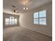 Bright living room featuring carpet flooring, neutral walls, ceiling fan, and windows at 10232 Grant Creek Dr, Tampa, FL 33647