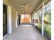 Covered and screened lanai features a ceiling fan with views of the backyard, ideal for relaxing outdoors at 10232 Grant Creek Dr, Tampa, FL 33647