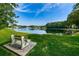 Scenic lake view featuring a fountain, surrounding foliage, and a bench to enjoy the view at 1433 Pine Glen Pl # G2, Tarpon Springs, FL 34688