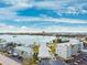 Scenic aerial view showcasing the building, pool, surrounding waterway, and cityscape in the distance at 1868 Shore S Dr # 209, South Pasadena, FL 33707