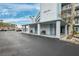 Exterior shot showcasing the building's entrance with benches, a tree, and parking at 1868 Shore S Dr # 209, South Pasadena, FL 33707