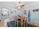 Cozy dining area featuring a wooden table, blue accent rug, and a view into the kitchen at 1868 Shore S Dr # 209, South Pasadena, FL 33707