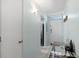 Bright hallway featuring a glass table, white walls, and an entry door with transom window at 1868 Shore S Dr # 209, South Pasadena, FL 33707