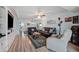 Inviting living room featuring a ceiling fan, recessed lighting, and sleek wood flooring throughout at 1868 Shore S Dr # 209, South Pasadena, FL 33707