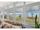 Sun-drenched sun room offering stunning views of the lush grounds and sparkling waterfront beyond at 1868 Shore S Dr # 209, South Pasadena, FL 33707
