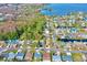 Scenic aerial view of houses near lush trees and a beautiful lake, showcasing neighborhood and landscape at 20 Cypress Dr, Palm Harbor, FL 34684