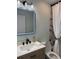 Stylish bathroom featuring black fixtures, modern mirror lighting, and a bathtub with a textured shower curtain at 20 Cypress Dr, Palm Harbor, FL 34684