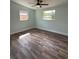 Bedroom features updated wood-look flooring, natural light, and neutral-toned walls at 20 Cypress Dr, Palm Harbor, FL 34684