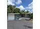 Charming single-story home with a well-maintained front yard and delightful blue door at 20 Cypress Dr, Palm Harbor, FL 34684