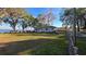 Charming home with lawn overlooking lakefront property and benches at 20 Cypress Dr, Palm Harbor, FL 34684