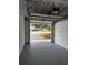 Spacious garage features an open door and a concrete floor at 20 Cypress Dr, Palm Harbor, FL 34684