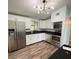 Updated kitchen boasts new stainless steel appliances, white cabinets, and stylish countertops at 20 Cypress Dr, Palm Harbor, FL 34684