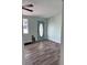 Charming living area has a front door with stained glass, light walls, and wood-look floors at 20 Cypress Dr, Palm Harbor, FL 34684