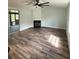 Bright living room with modern wood-look flooring and black tiled fireplace at 20 Cypress Dr, Palm Harbor, FL 34684
