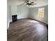 Bright living room with luxury vinyl plank flooring, ceiling fan, and fireplace at 20 Cypress Dr, Palm Harbor, FL 34684