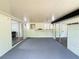 Enclosed porch with gray floors, wet bar, and sliding glass doors at 20 Cypress Dr, Palm Harbor, FL 34684
