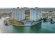 Waterfront condominium complex with towers, a pool, tennis court, and lush landscaping on a peninsula at 420 64Th Ave # 1005, St Pete Beach, FL 33706