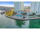 Aerial shot of condo community with swimming pool, shuffleboard court, and boat docks at 420 64Th Ave # 1005, St Pete Beach, FL 33706
