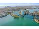 An aerial view of two condo buildings surrounded by water and tropical landscaping at 420 64Th Ave # 1005, St Pete Beach, FL 33706