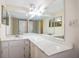 Bathroom features a white vanity, marble countertop, and a large mirror at 420 64Th Ave # 1005, St Pete Beach, FL 33706