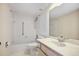 Bathroom featuring a tiled shower-tub combination, toilet, and vanity at 420 64Th Ave # 1005, St Pete Beach, FL 33706