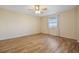 Bedroom with a ceiling fan, hardwood floors, and a window with a view at 420 64Th Ave # 1005, St Pete Beach, FL 33706