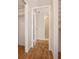 Hallway with wood-look floors that lead to multiple rooms at 420 64Th Ave # 1005, St Pete Beach, FL 33706