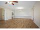 Open-concept living room featuring laminate flooring, a chandelier, and a neutral color palette at 420 64Th Ave # 1005, St Pete Beach, FL 33706