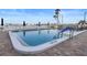 Community pool with lounge chairs surrounded by lush tropical landscaping at 420 64Th Ave # 1005, St Pete Beach, FL 33706