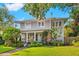 Charming two-story home features a manicured lawn, lush greenery, and inviting front porch at 425 20Th Ne Ave, St Petersburg, FL 33704