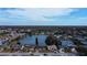Beautiful aerial view of homes surrounding a serene lake in a quiet residential neighborhood at 4728 Swallowtail Dr, New Port Richey, FL 34653