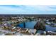 Expansive aerial view shows a waterfront community with lush landscaping under a blue sky at 4728 Swallowtail Dr, New Port Richey, FL 34653