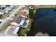 Aerial view showcases home with waterfront access and a pool in a peaceful neighborhood at 4728 Swallowtail Dr, New Port Richey, FL 34653
