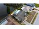 Aerial view of house with pool in backyard along a lake in a residential neighborhood at 4728 Swallowtail Dr, New Port Richey, FL 34653