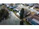 Aerial view of a waterfront property with a pool in a residential neighborhood on a sunny day at 4728 Swallowtail Dr, New Port Richey, FL 34653