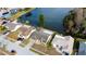 Aerial view showcases waterfront homes with lush landscaping in a well-maintained neighborhood at 4728 Swallowtail Dr, New Port Richey, FL 34653